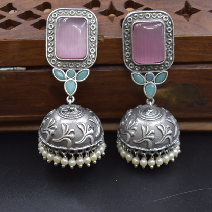 A pair of silver look alike stone stud jhumka earing