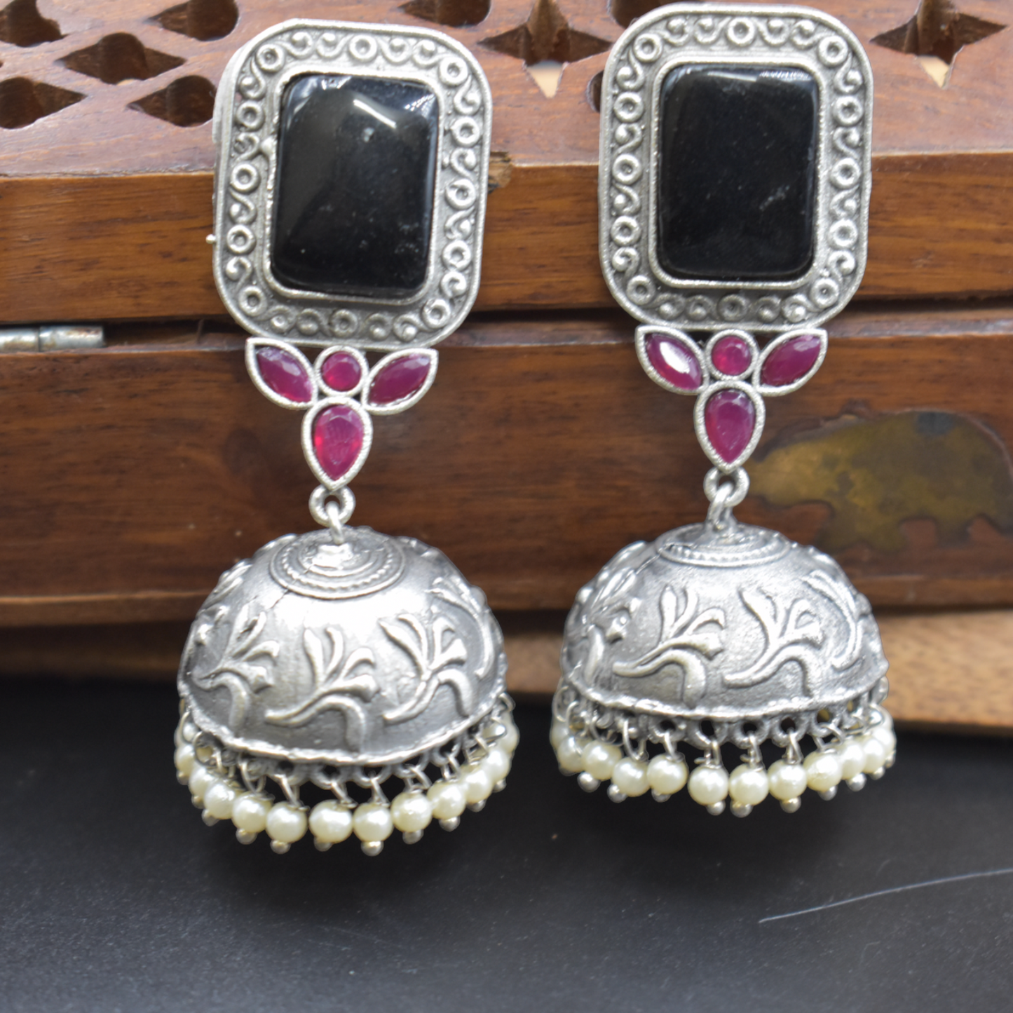 A pair of silver look alike stone stud jhumka earing