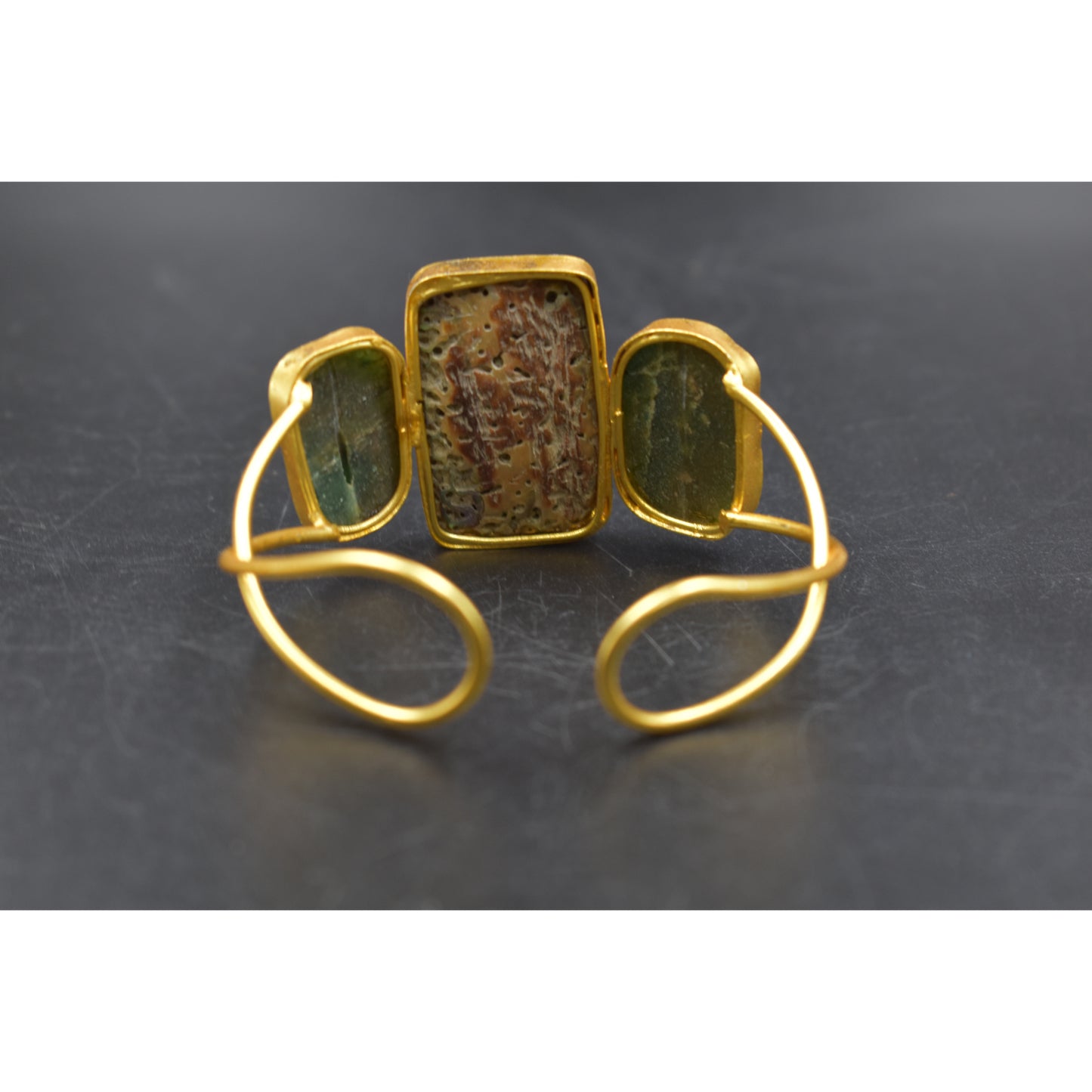 A piece of goldplated semiprecious stone bangle