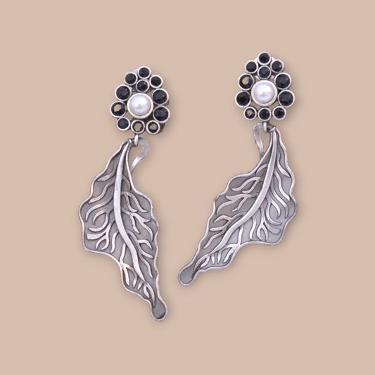 A pair of Leaf design silver look alike stone stud earing