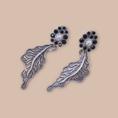 A pair of Leaf design silver look alike stone stud earing